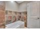 Bathroom featuring a bathtub decorated with decorative tile and updated fixtures at 13806 N Del Webb Blvd, Sun City, AZ 85351