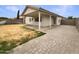Backyard featuring a covered patio, block wall and pavers at 1399 E Santa Fiore St, San Tan Valley, AZ 85140