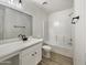 Clean bathroom with white vanity, black hardware, and tiled shower/tub at 1399 E Santa Fiore St, San Tan Valley, AZ 85140
