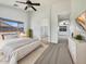 Bright main bedroom features a ceiling fan, a neutral color palette, and ensuite bathroom entrance at 1399 E Santa Fiore St, San Tan Valley, AZ 85140