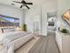 Sunlit primary bedroom suite with a large window and ensuite bathroom at 1399 E Santa Fiore St, San Tan Valley, AZ 85140
