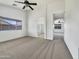 Spacious primary bedroom featuring carpeted flooring and a large window at 1399 E Santa Fiore St, San Tan Valley, AZ 85140