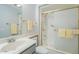 Well-maintained bathroom with a white sink, toilet, and a shower featuring a sliding glass door at 14080 N Newcastle Dr, Sun City, AZ 85351