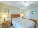 Cozy bedroom features a comfortable bed with patterned linens, bedside tables with lamps, and neutral walls at 14080 N Newcastle Dr, Sun City, AZ 85351