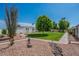 Well-maintained community landscape with green lawns, mature trees, and decorative rock features, offering a serene setting at 14080 N Newcastle Dr, Sun City, AZ 85351