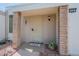 Inviting home entry featuring covered porch with brick supports and a secure screen door at 14080 N Newcastle Dr, Sun City, AZ 85351