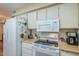 Functional kitchen with white appliances, light wood countertops, and plenty of cabinet space at 14080 N Newcastle Dr, Sun City, AZ 85351