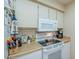 Efficient kitchen layout, features white appliances, ample counter space, and microwave at 14080 N Newcastle Dr, Sun City, AZ 85351