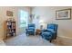 Cozy living area with matching recliner chairs, soft carpet, and natural light from large window at 14080 N Newcastle Dr, Sun City, AZ 85351