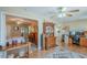 Open living room with hardwood floors, display cabinet, and access to the bedroom, kitchen, and office spaces at 14080 N Newcastle Dr, Sun City, AZ 85351