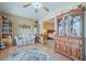 Inviting living room with hardwood floors, comfortable seating, and display cabinets, showcasing a warm and welcoming atmosphere at 14080 N Newcastle Dr, Sun City, AZ 85351