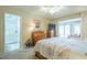 Spacious main bedroom with en-suite bathroom, television, and sliding doors leading to the patio for easy outdoor access at 14080 N Newcastle Dr, Sun City, AZ 85351