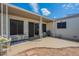 Covered patio area featuring outdoor seating, a sliding glass door, and a view of the surrounding yard at 14080 N Newcastle Dr, Sun City, AZ 85351