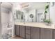 Well-lit bathroom with gray vanity, double sinks, and a shower-tub combination at 1446 E Douglas St, Casa Grande, AZ 85122