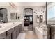 Modern bathroom with a soaking tub, glass-enclosed shower, and double vanity sinks at 1446 E Douglas St, Casa Grande, AZ 85122