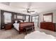 Cozy bedroom features a ceiling fan, carpeted floors, and a comfortable bed with soft lighting at 1446 E Douglas St, Casa Grande, AZ 85122
