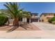 Two-story home with desert landscaping, brick accents, and a large palm tree in the front yard at 1446 E Douglas St, Casa Grande, AZ 85122