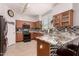Well-lit kitchen boasts granite countertops, a tile backsplash, and stainless steel appliances at 1446 E Douglas St, Casa Grande, AZ 85122