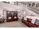 Open-concept living room with plush seating, neutral colors, and a staircase to the second floor at 1446 E Douglas St, Casa Grande, AZ 85122