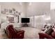 Bright living room featuring tall ceilings, plush carpet, ample seating, and large windows at 1446 E Douglas St, Casa Grande, AZ 85122