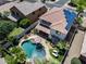 Aerial view of home featuring a backyard pool, patio seating, and well-manicured landscaping at 14878 W Windrose Dr, Surprise, AZ 85379