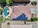 An aerial view of a house with solar panels, a tile roof, and a backyard pool at 14878 W Windrose Dr, Surprise, AZ 85379