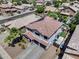 An aerial view showcases a spacious home, solar panels, desert landscaping, and a backyard pool at 14878 W Windrose Dr, Surprise, AZ 85379