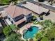 Aerial view of a property with a pool, patio furniture, and solar panels on the roof at 14878 W Windrose Dr, Surprise, AZ 85379