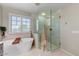 Beautiful bathroom featuring a soaking tub and a glass-enclosed walk-in shower at 14878 W Windrose Dr, Surprise, AZ 85379