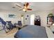 Comfortable bedroom featuring ample natural light, a ceiling fan, and relaxing decor at 14878 W Windrose Dr, Surprise, AZ 85379