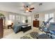 Comfortable bedroom featuring ample natural light, a ceiling fan, and relaxing decor at 14878 W Windrose Dr, Surprise, AZ 85379