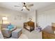 Charming Bedroom with a crib, comfortable armchair, and soft decor for a cozy atmosphere at 14878 W Windrose Dr, Surprise, AZ 85379