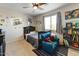 A bedroom with a single bed, an accent chair and colorful wall decorations at 14878 W Windrose Dr, Surprise, AZ 85379