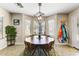 Stylish dining area features modern lighting, ample natural light, and a view of the backyard at 14878 W Windrose Dr, Surprise, AZ 85379