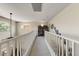 Bright upstairs hallway with white railing, neutral carpeting and a built-in bookcase at 14878 W Windrose Dr, Surprise, AZ 85379