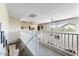 Second floor hallway with modern railing and arched windows offering natural light and views at 14878 W Windrose Dr, Surprise, AZ 85379