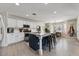 Spacious kitchen featuring an island with barstool seating, white cabinets, and stainless steel appliances at 14878 W Windrose Dr, Surprise, AZ 85379