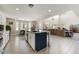 Open concept kitchen flows into the living room and features an island with barstool seating at 14878 W Windrose Dr, Surprise, AZ 85379