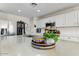 Close up shot of a large kitchen island featuring a prep sink, decor, and stainless steel appliances at 14878 W Windrose Dr, Surprise, AZ 85379