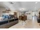 Bright living room featuring neutral colors, stylish light fixture, large windows and wood-look flooring at 14878 W Windrose Dr, Surprise, AZ 85379