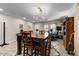 Bright living room featuring neutral colors, stylish light fixture, large windows and wood-look flooring at 14878 W Windrose Dr, Surprise, AZ 85379