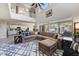 Spacious living room with high ceilings, large windows, and a comfortable seating area at 14878 W Windrose Dr, Surprise, AZ 85379