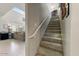 Carpeted staircase leading to the second floor, with a view of the living room at 14878 W Windrose Dr, Surprise, AZ 85379