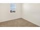 Small bedroom offers a bright window and plush carpeting for a cozy feel at 16010 W Desert Hollow Dr, Surprise, AZ 85387