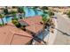 Aerial view of a property featuring a red tile roof, multiple garages, and waterfront access on a scenic canal at 1625 W Gunstock Loop, Chandler, AZ 85286