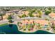 Expansive neighborhood view of a home with a lush green lawn and beautiful lake frontage at 1625 W Gunstock Loop, Chandler, AZ 85286