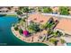 Aerial view of a waterfront property with a red tile roof, manicured landscaping, and serene canal access at 1625 W Gunstock Loop, Chandler, AZ 85286