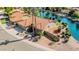 Aerial view of a residential property with a red tile roof, lush landscaping, and waterfront access at 1625 W Gunstock Loop, Chandler, AZ 85286