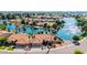 Scenic view of a home nestled on a serene lake with mature trees and manicured lawns at 1625 W Gunstock Loop, Chandler, AZ 85286