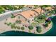Beautiful waterfront property featuring a covered patio, landscaped yard, and picturesque lake views at 1625 W Gunstock Loop, Chandler, AZ 85286